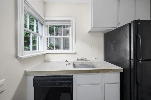 a kitchen with a sink and a refrigerator