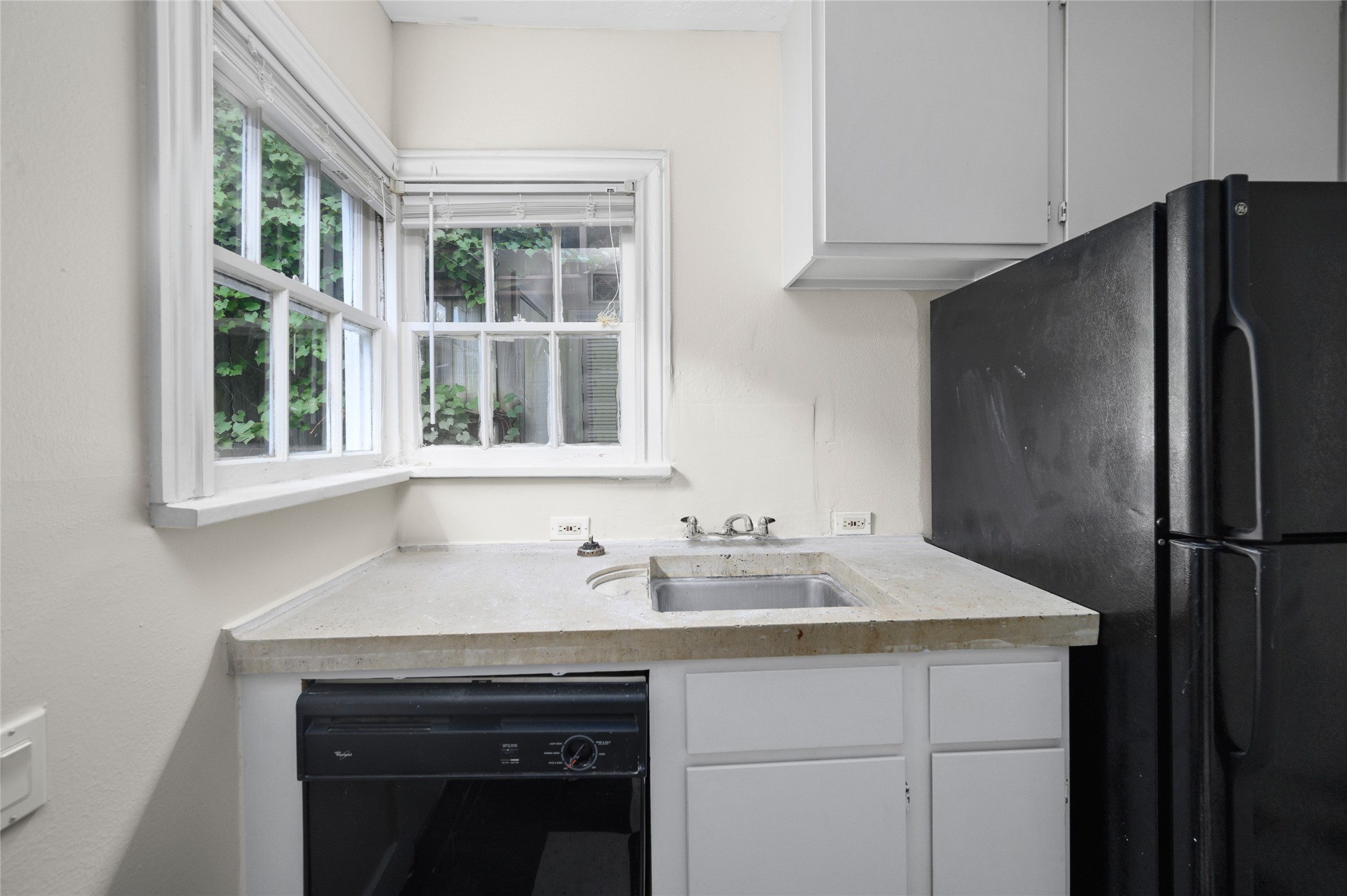 1955 Lexington Street, Unit A Houston, TX 77098 - Photo 11 of 12 a kitchen with a sink and a refrigerator