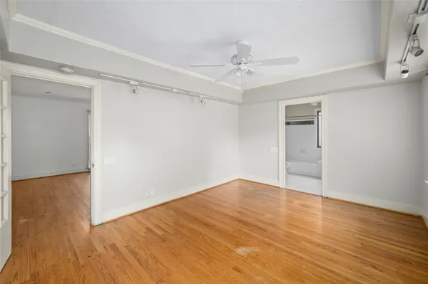 a view of an empty room with wooden floor