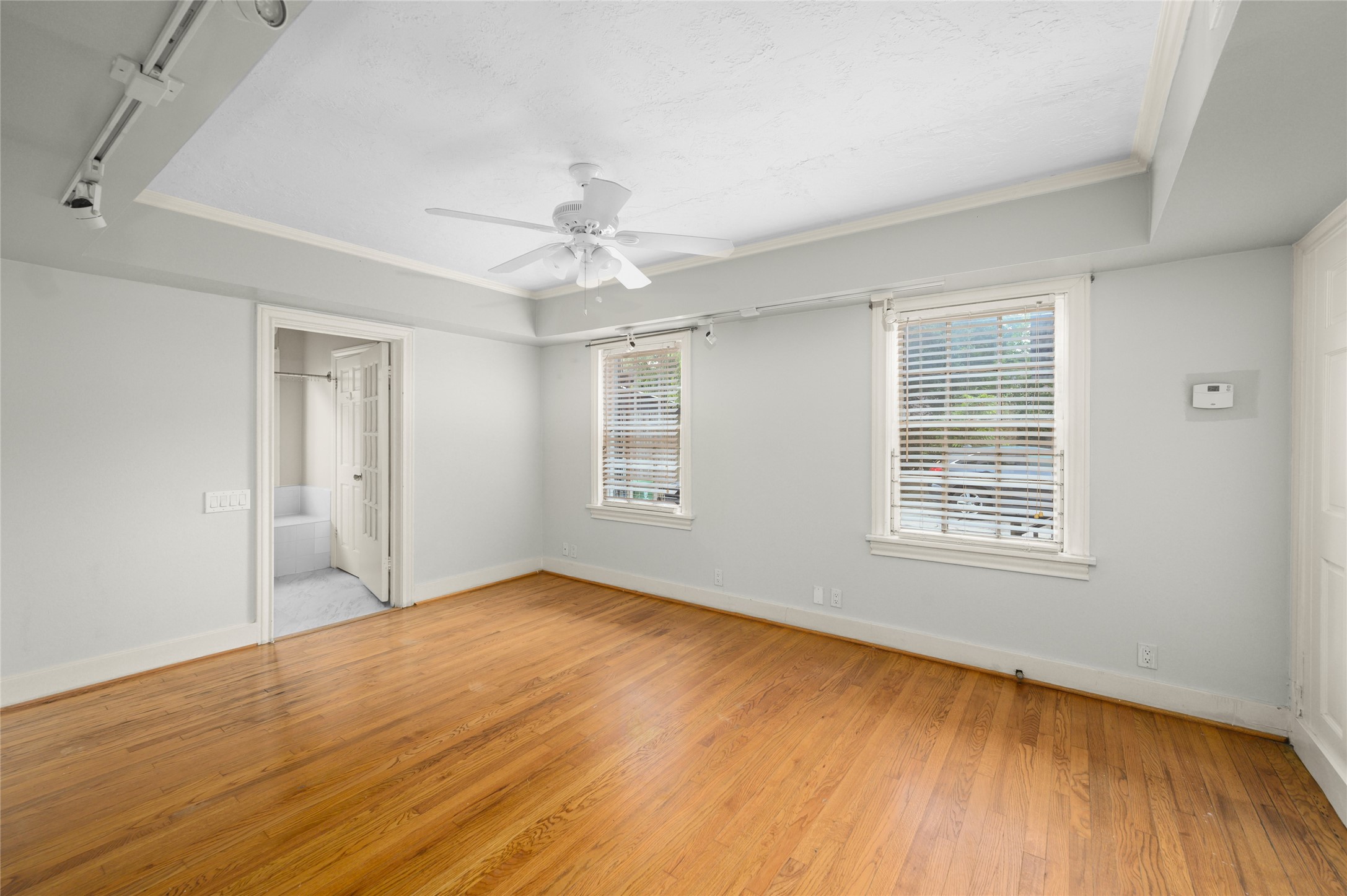 1955 Lexington Street, Unit A Houston, TX 77098 - Photo 7 of 12 a view of an empty room with wooden floor and a window