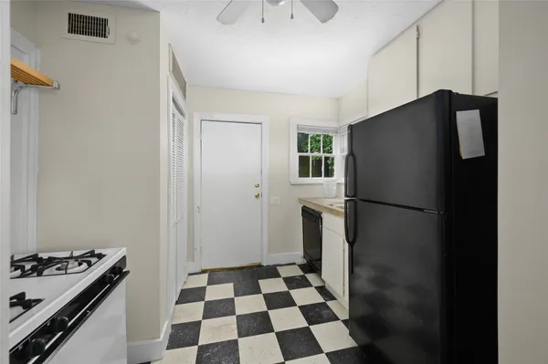 a kitchen with a refrigerator and a stove