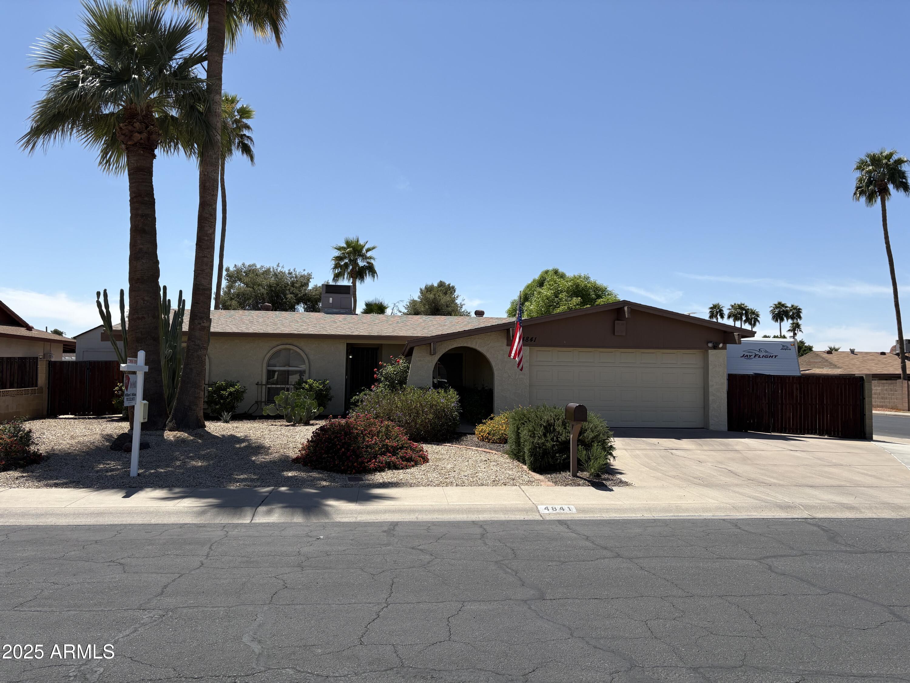 4841 West Mercer Lane Glendale, AZ 85304 - Photo 1 of 15 a view of a terrace with a chair and table on the road