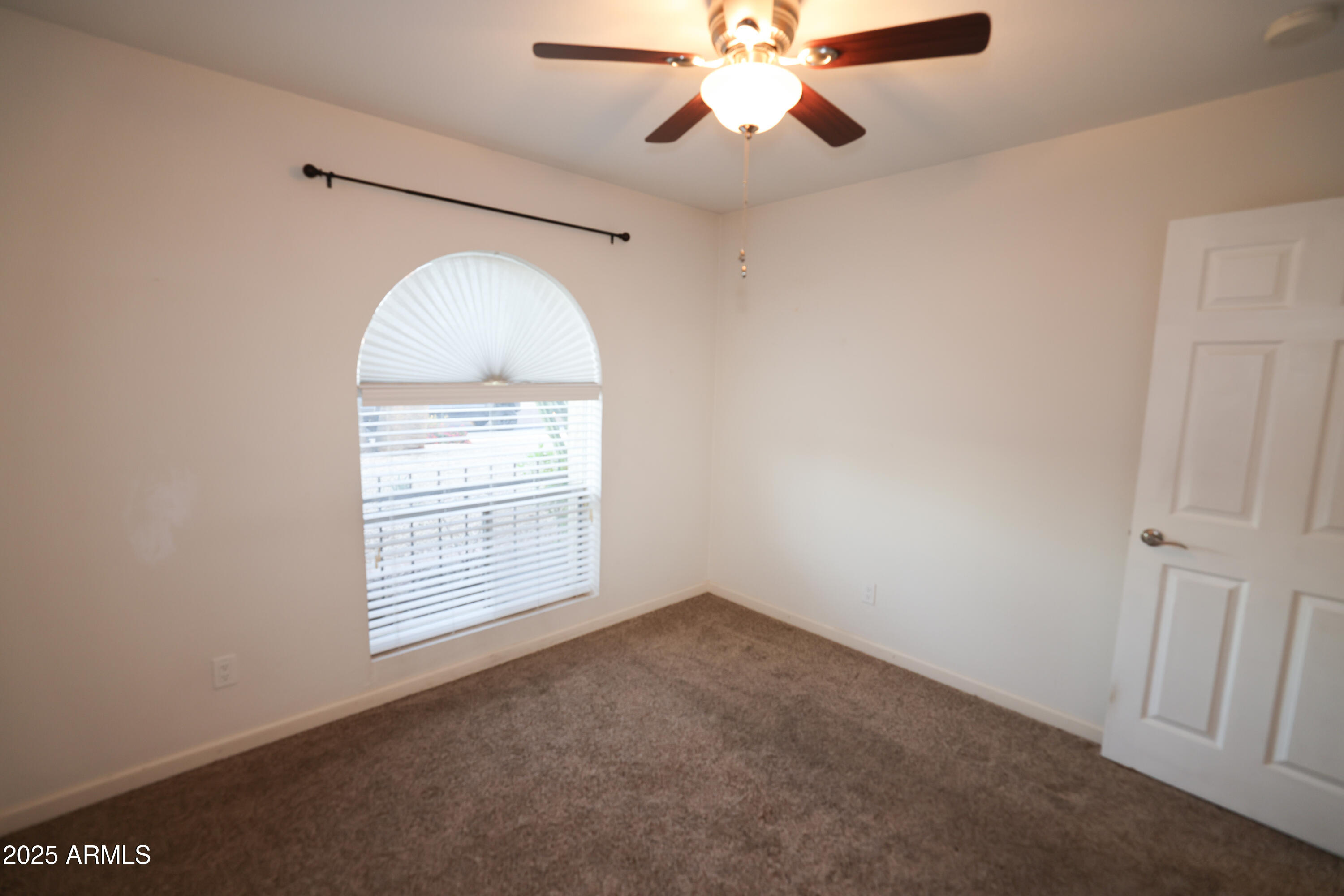 4841 West Mercer Lane Glendale, AZ 85304 - Photo 11 of 15 en empty room with windows and fan