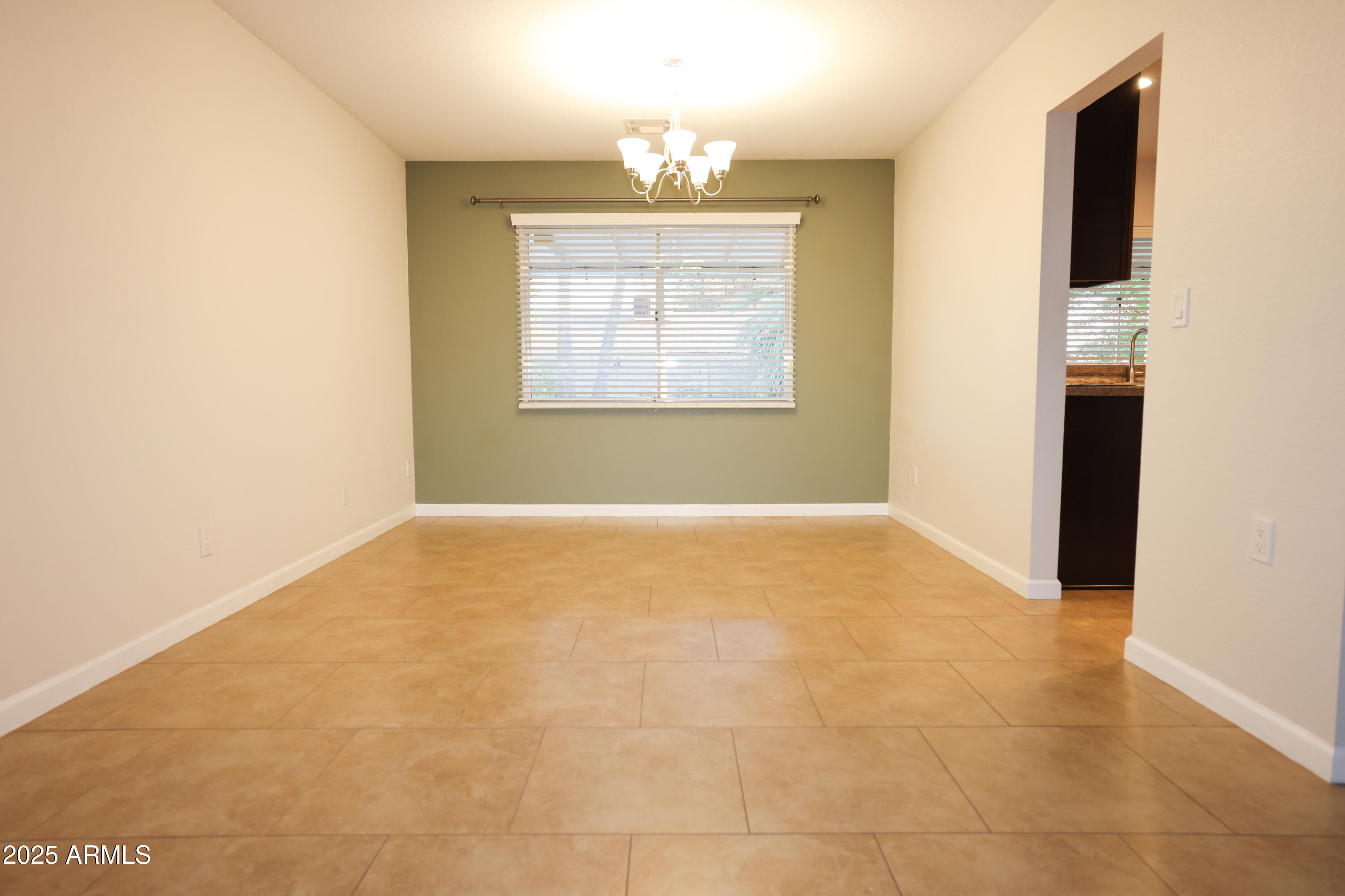 4841 West Mercer Lane Glendale, AZ 85304 - Photo 3 of 15 a view of an empty room with a window