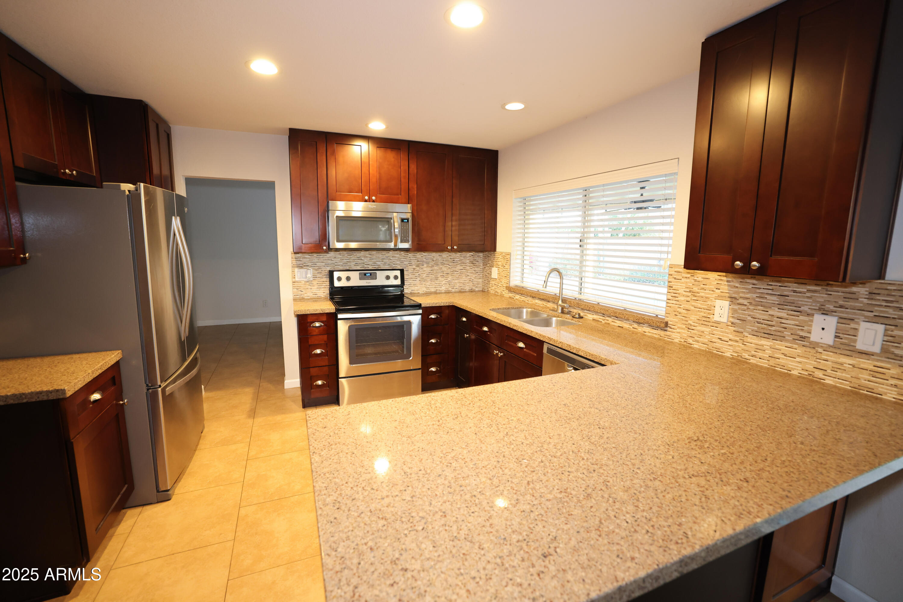 4841 West Mercer Lane Glendale, AZ 85304 - Photo 6 of 15 a kitchen with stainless steel appliances a refrigerator and a sink