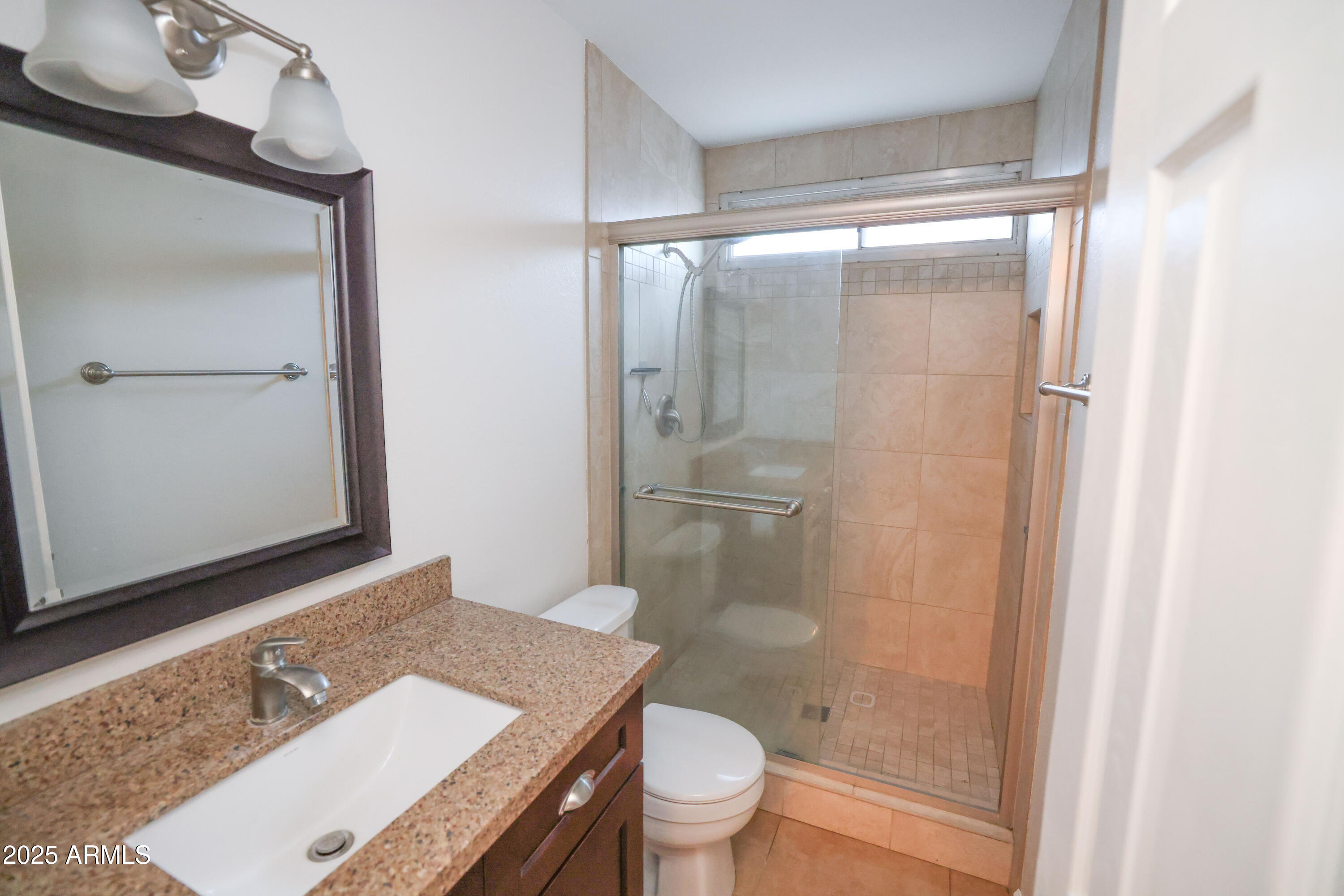 4841 West Mercer Lane Glendale, AZ 85304 - Photo 9 of 15 a bathroom with a granite countertop sink toilet and shower