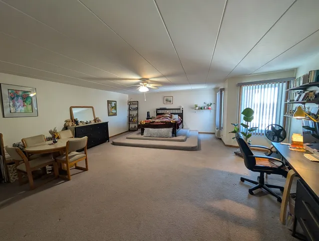 a living room with furniture a piano and a window