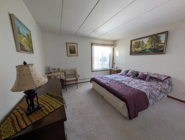 a bedroom with bed and window