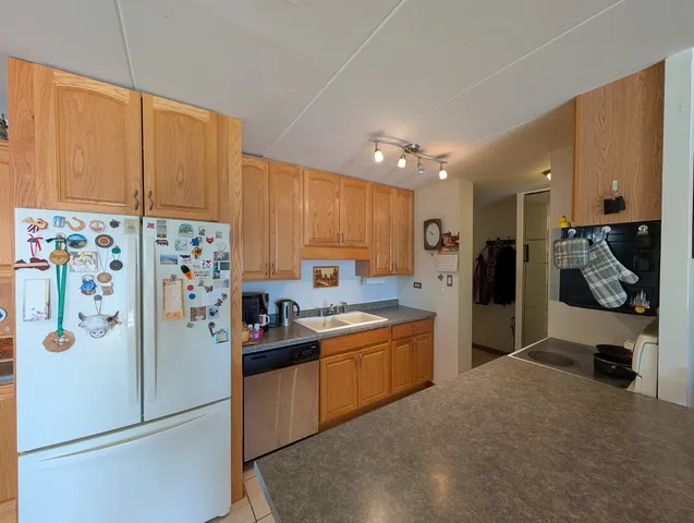 a kitchen with stainless steel appliances a refrigerator sink and cabinets