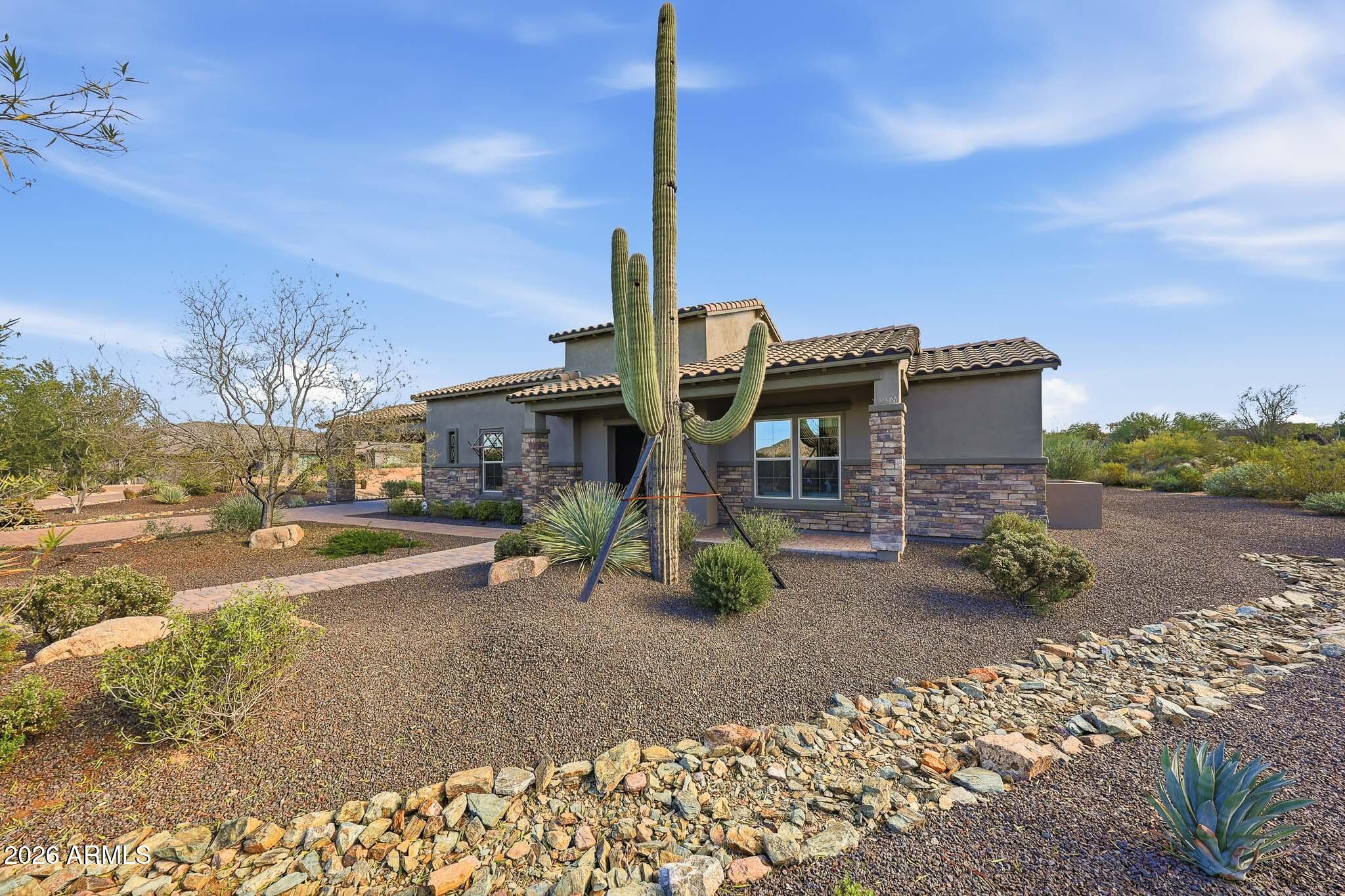 8597 East Arroyo Seco Road Scottsdale, AZ 85266 - Photo 11 of 73 a front view of a house with garden