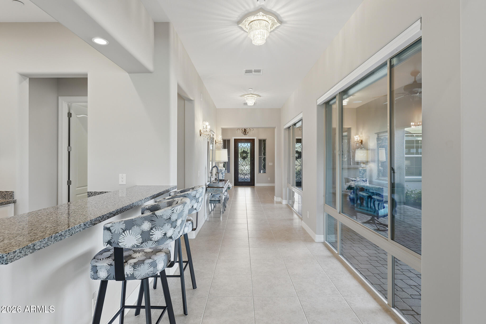 8597 East Arroyo Seco Road Scottsdale, AZ 85266 - Photo 18 of 73 a view of a hallway with wooden floor and windows