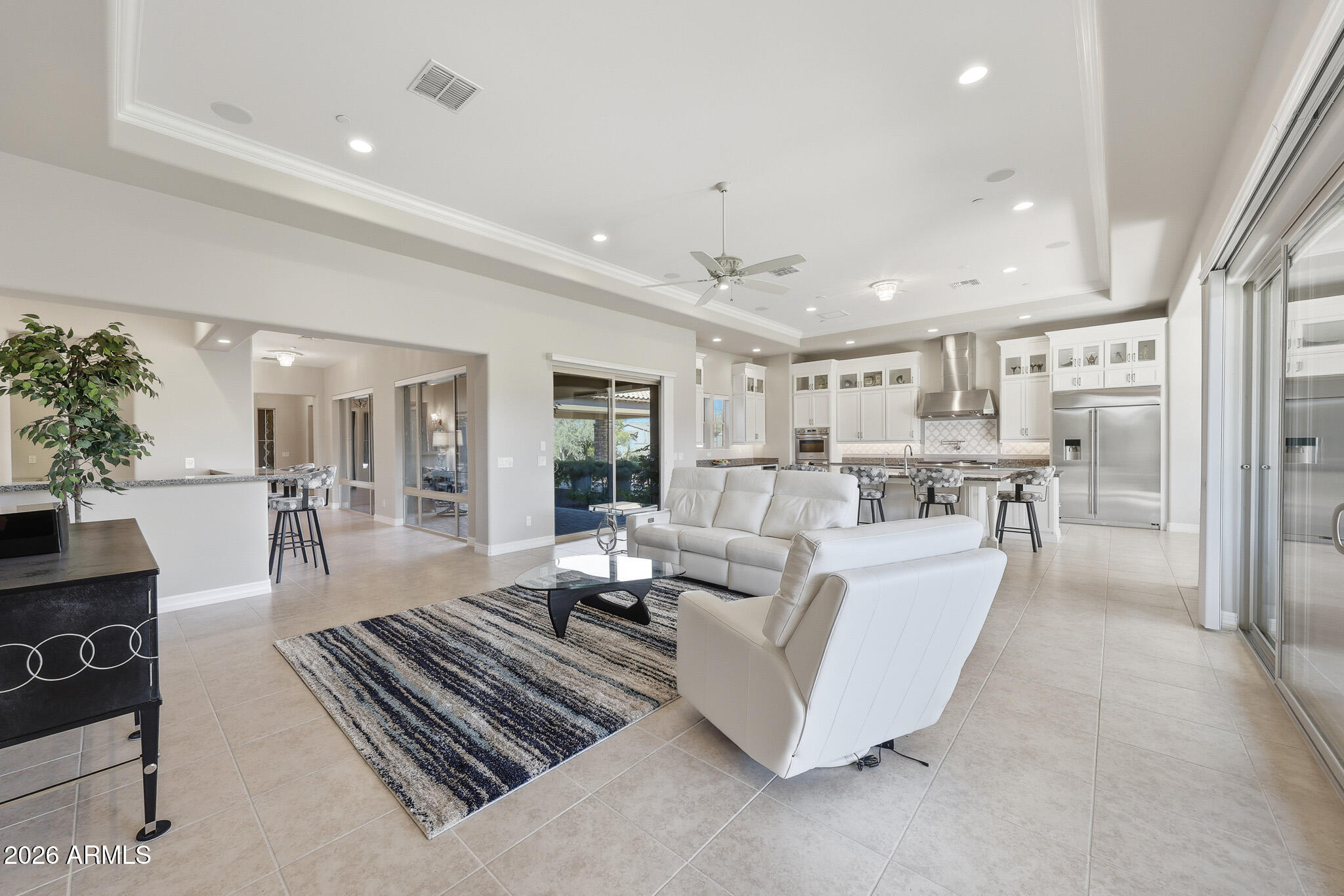 8597 East Arroyo Seco Road Scottsdale, AZ 85266 - Photo 22 of 73 a living room with couches and kitchen view with wooden floor