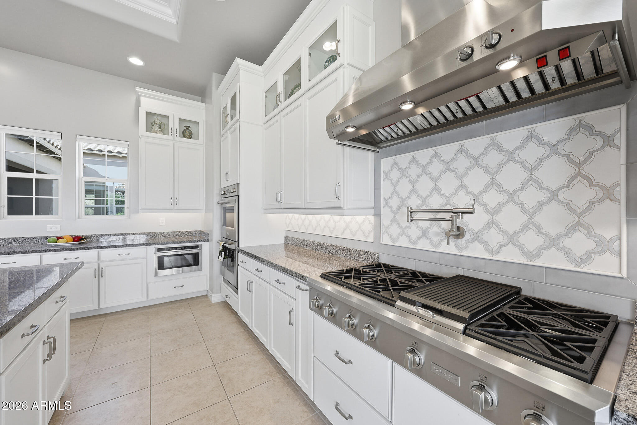 8597 East Arroyo Seco Road Scottsdale, AZ 85266 - Photo 25 of 73 a kitchen with stainless steel appliances granite countertop a stove and a sink