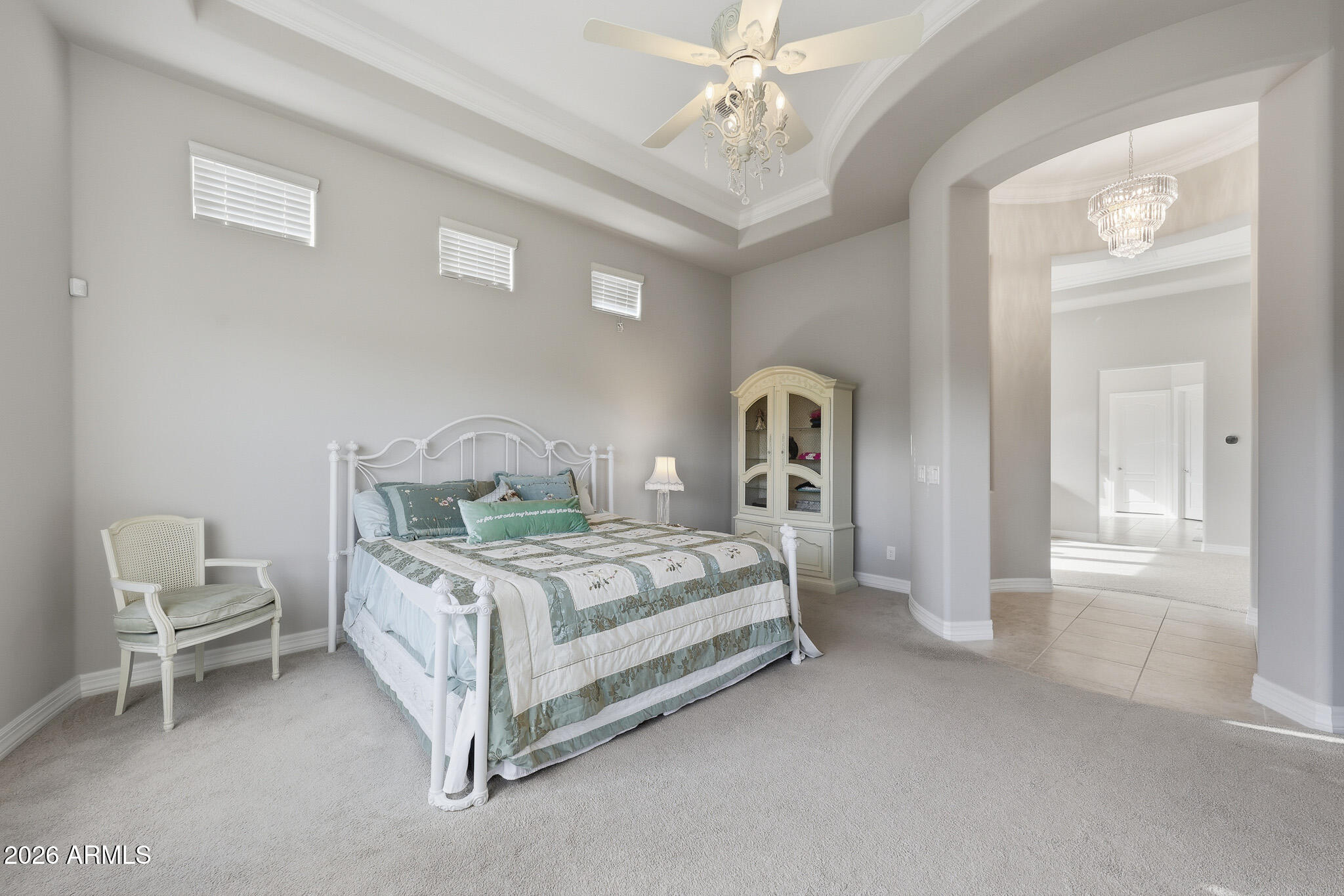 8597 East Arroyo Seco Road Scottsdale, AZ 85266 - Photo 32 of 73 a bedroom with a bed and a chandelier