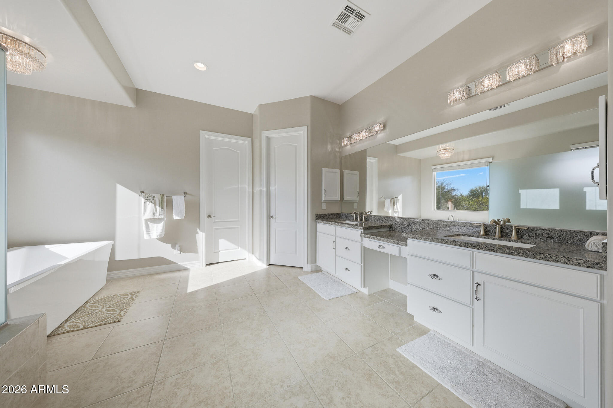 8597 East Arroyo Seco Road Scottsdale, AZ 85266 - Photo 39 of 73 a large bathroom with a granite countertop sink mirror and a bathtub