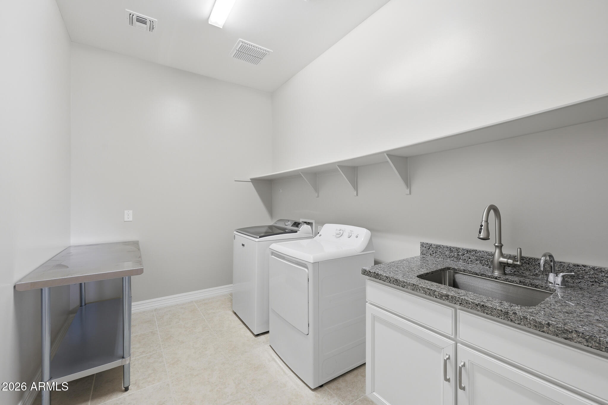 8597 East Arroyo Seco Road Scottsdale, AZ 85266 - Photo 43 of 73 a utility room with cabinets washer and dryer