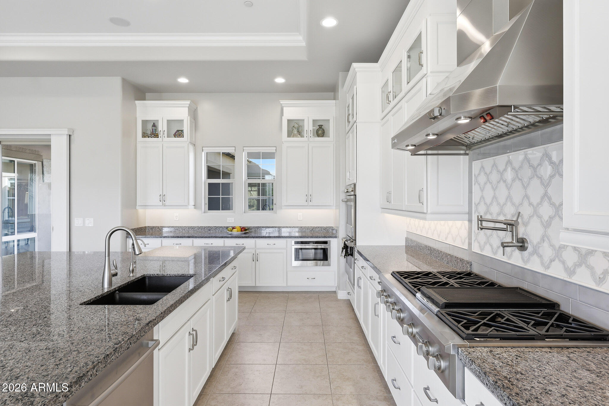 8597 East Arroyo Seco Road Scottsdale, AZ 85266 - Photo 6 of 73 a large kitchen with stainless steel appliances granite countertop a stove and a sink