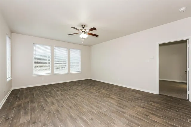 wooden floor in an empty room with a window
