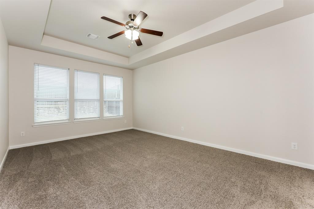 9430 Smoke Tree Drive Forney, TX 75126 - Photo 7 of 17 an empty room with windows and ceiling fan