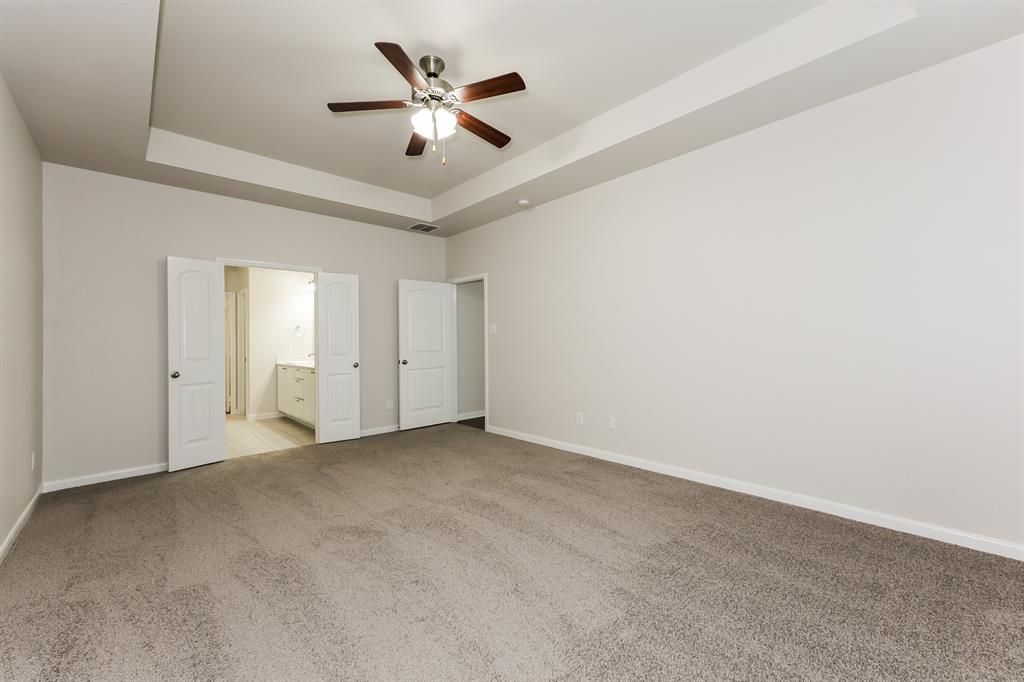 9430 Smoke Tree Drive Forney, TX 75126 - Photo 8 of 17 an empty room with a ceiling fan and a window