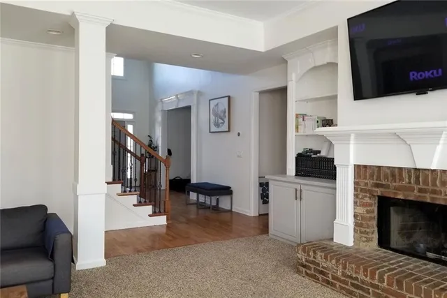 a living room with furniture fireplace and flat screen tv