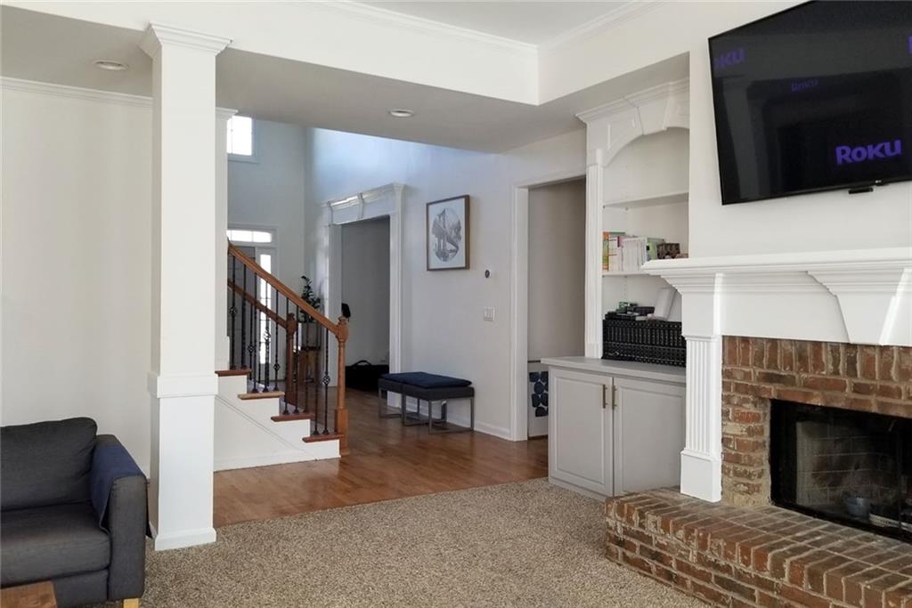 1799 Mapmaker Drive Northeast Dacula, GA 30019 - Photo 13 of 69 a living room with furniture and a fireplace
