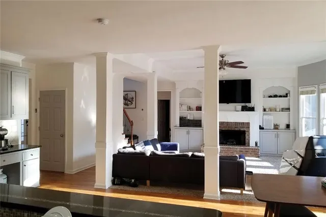 a living room with furniture and wooden floor