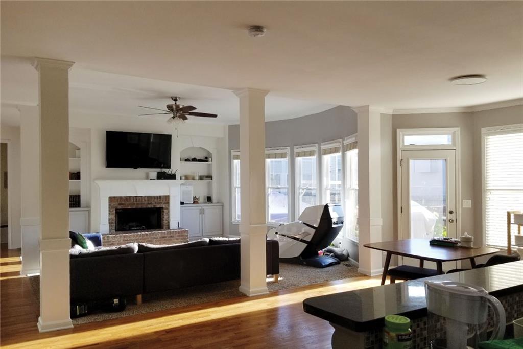 1799 Mapmaker Drive Northeast Dacula, GA 30019 - Photo 15 of 69 a living room with furniture a fireplace and a flat screen tv