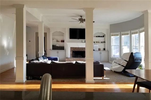 a living room with stainless steel appliances kitchen island granite countertop furniture and a view of kitchen