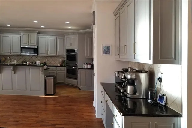 a view of entryway with wooden floor and stairs
