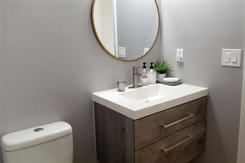 1799 Mapmaker Drive Northeast Dacula, GA 30019 - Photo 24 of 69 a bathroom with a sink a mirror and a toilet
