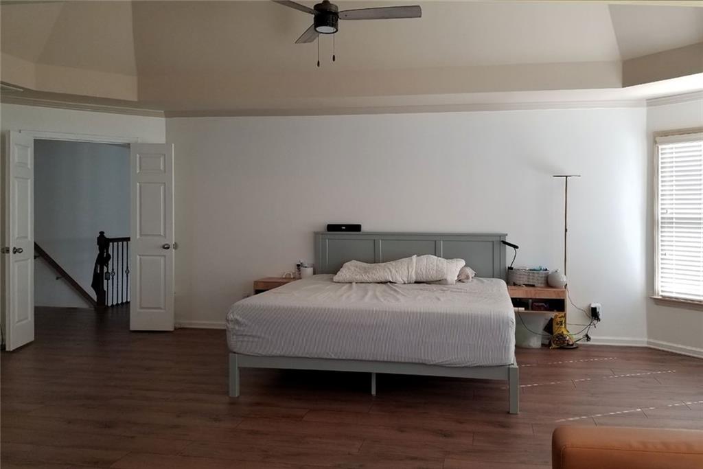 1799 Mapmaker Drive Northeast Dacula, GA 30019 - Photo 34 of 69 a bedroom with a bed and wooden floor