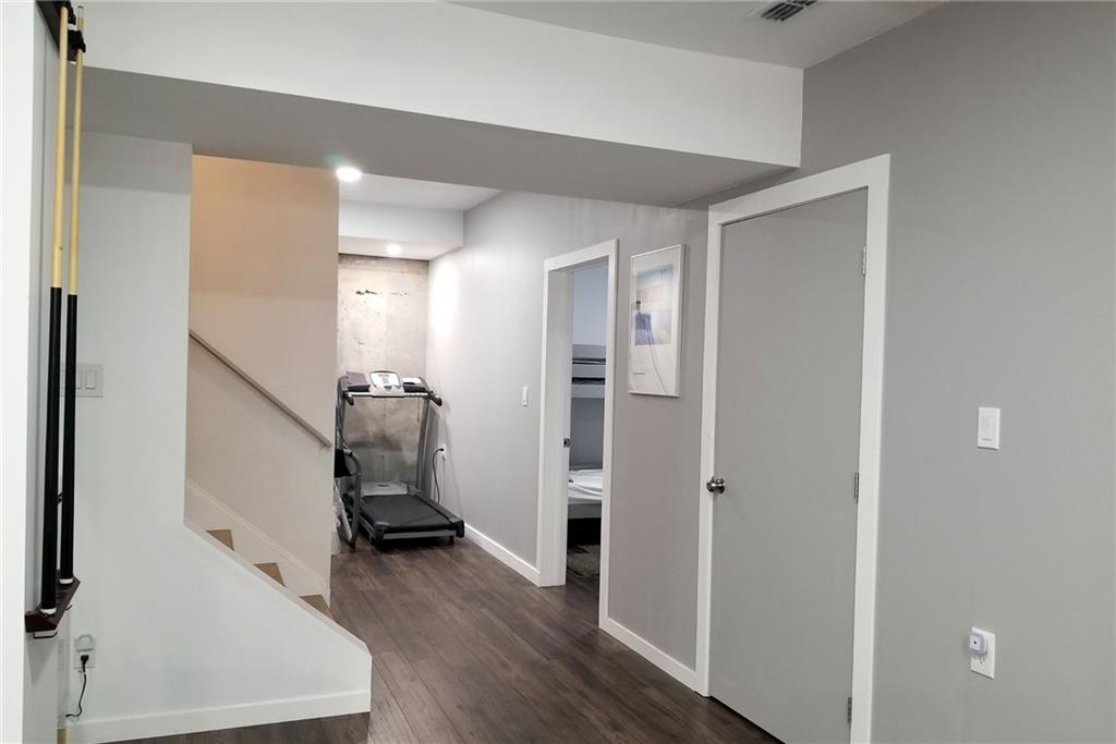 1799 Mapmaker Drive Northeast Dacula, GA 30019 - Photo 46 of 69 a view of a hallway with wooden floor and staircase