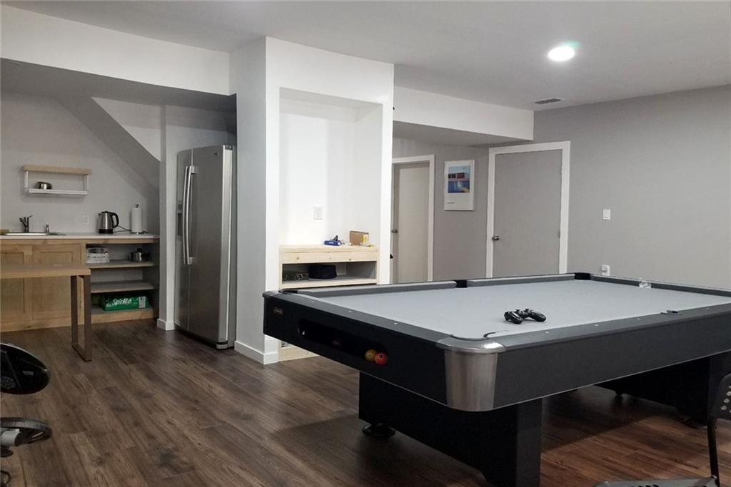 1799 Mapmaker Drive Northeast Dacula, GA 30019 - Photo 50 of 69 a room with furniture pool table and wooden floor