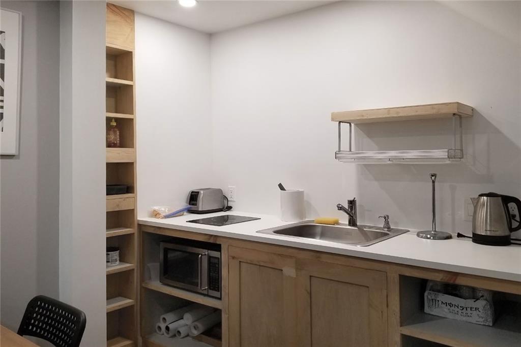 1799 Mapmaker Drive Northeast Dacula, GA 30019 - Photo 52 of 69 a kitchen with stainless steel appliances a sink and cabinets