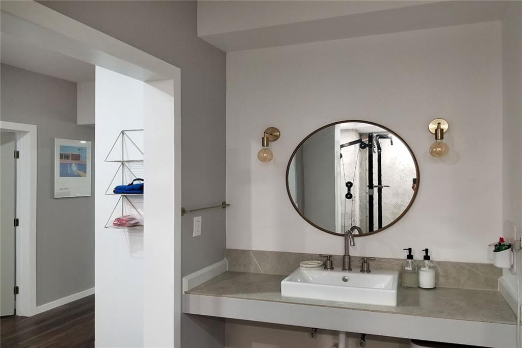 1799 Mapmaker Drive Northeast Dacula, GA 30019 - Photo 55 of 69 a bathroom with a sink and a mirror