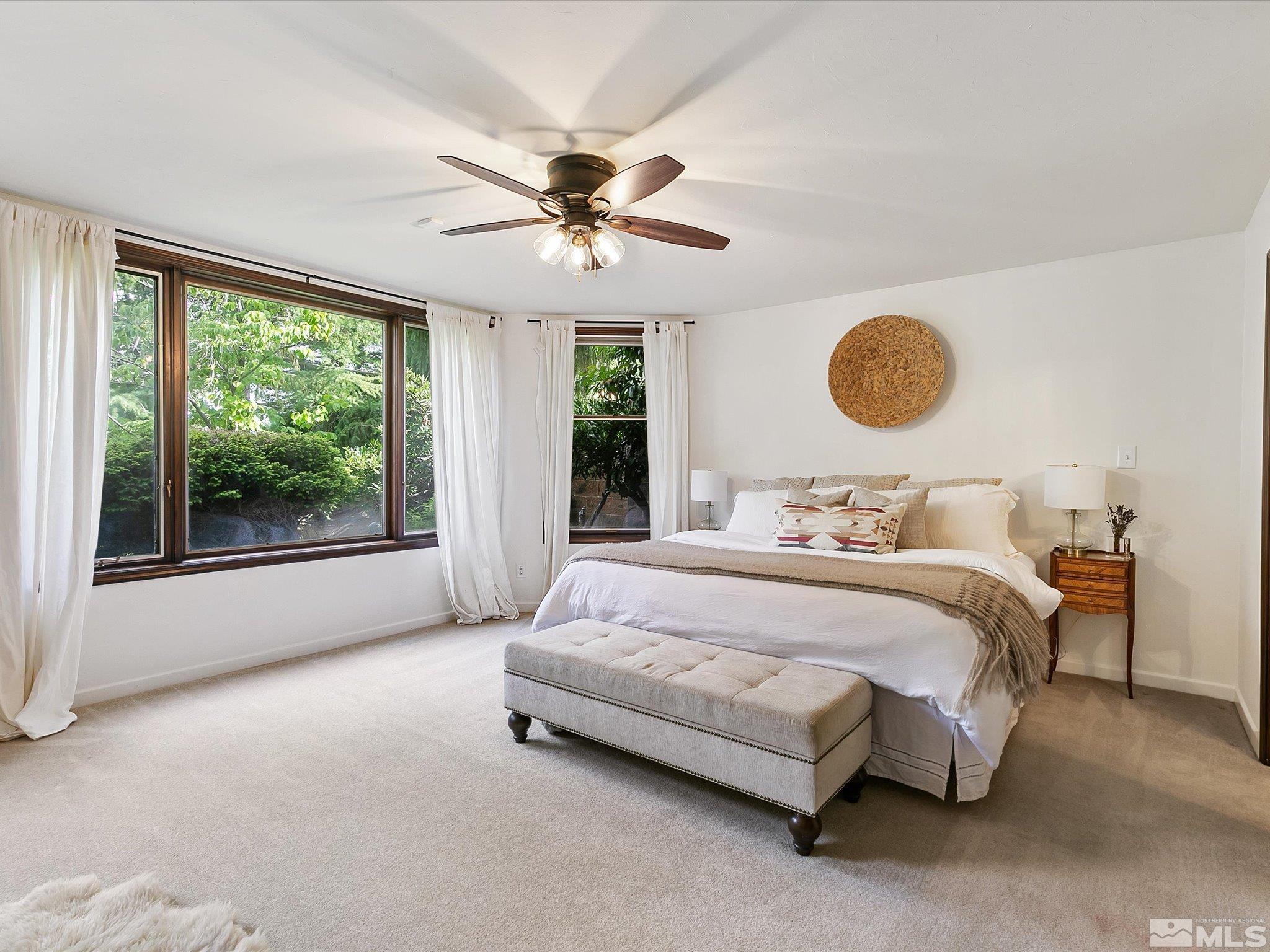 2585 West Lake Ridge Reno, NV 89519 - Photo 27 of 40 a spacious bedroom with a bed mirror and window