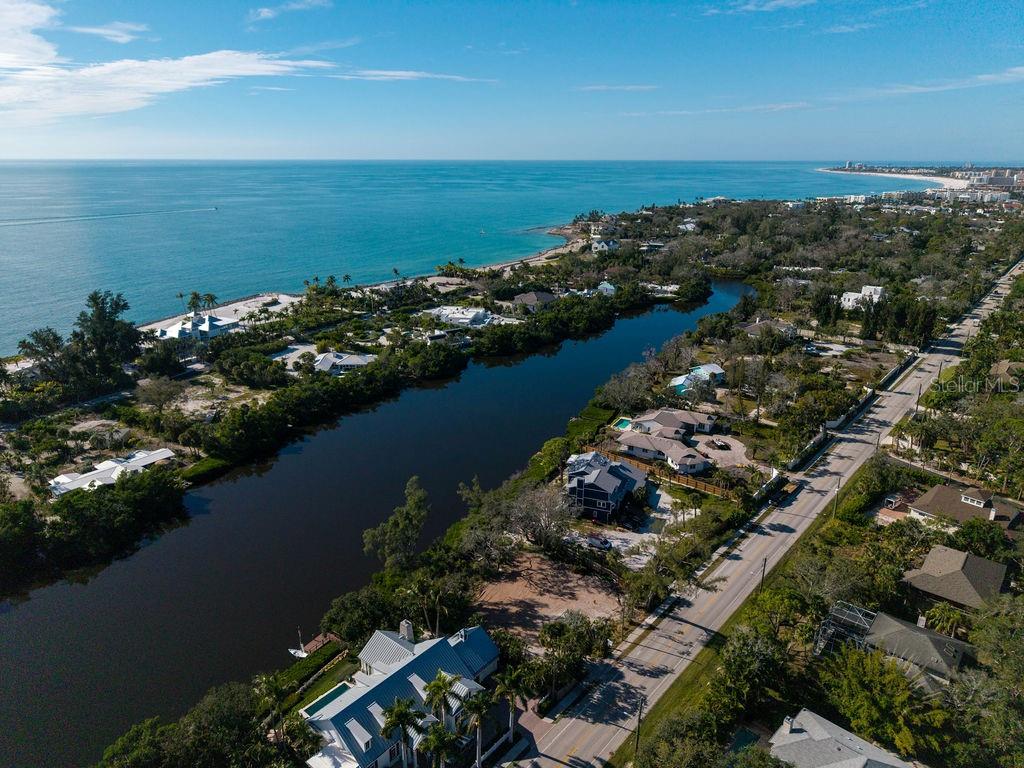 7676 Midnight Pass Road Sarasota, FL 34242 - Photo 2 of 20 an aerial view of ocean and residential houses with outdoor space