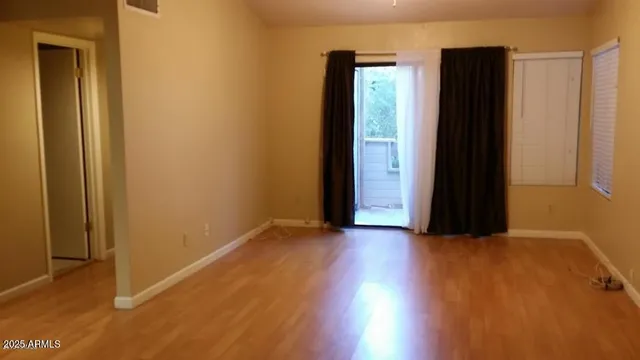 an empty room with closet and mirror