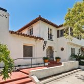 a view of house with yard and outdoor seating