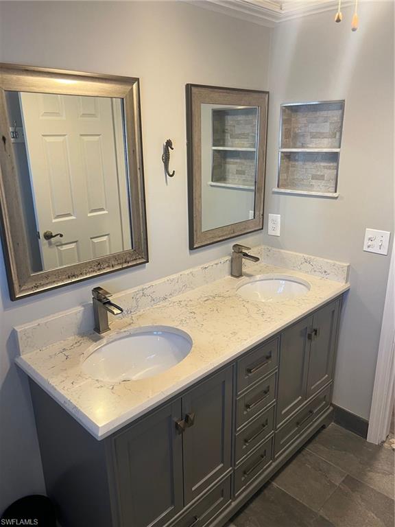 1790 Imperial Golf Course Boulevard, Unit A205 Naples, FL 34110 - Photo 11 of 28 a bathroom with a sink and a mirror