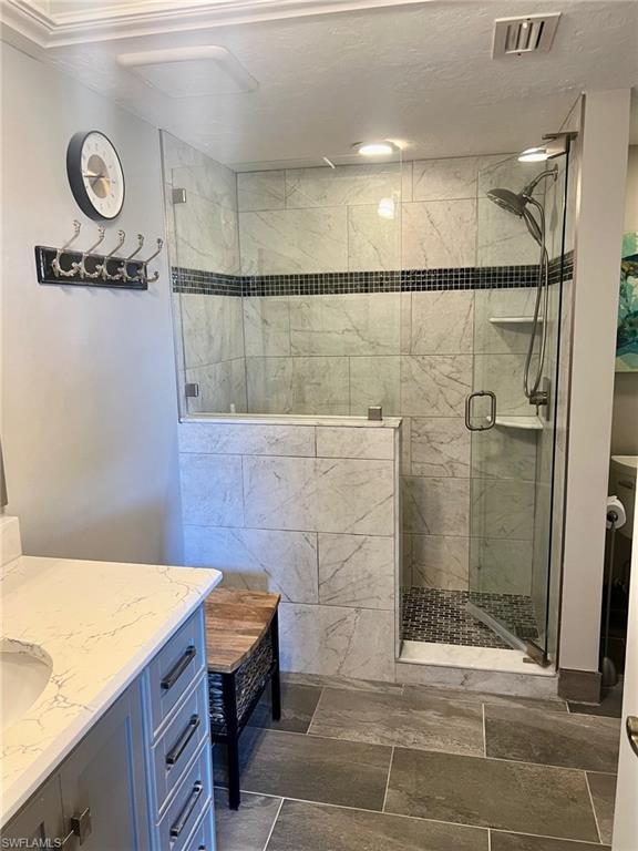 1790 Imperial Golf Course Boulevard, Unit A205 Naples, FL 34110 - Photo 15 of 28 a bathroom with a sink and a shower