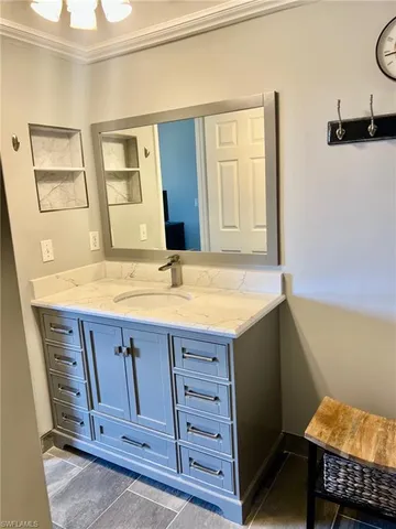 a bathroom with a sink and a mirror