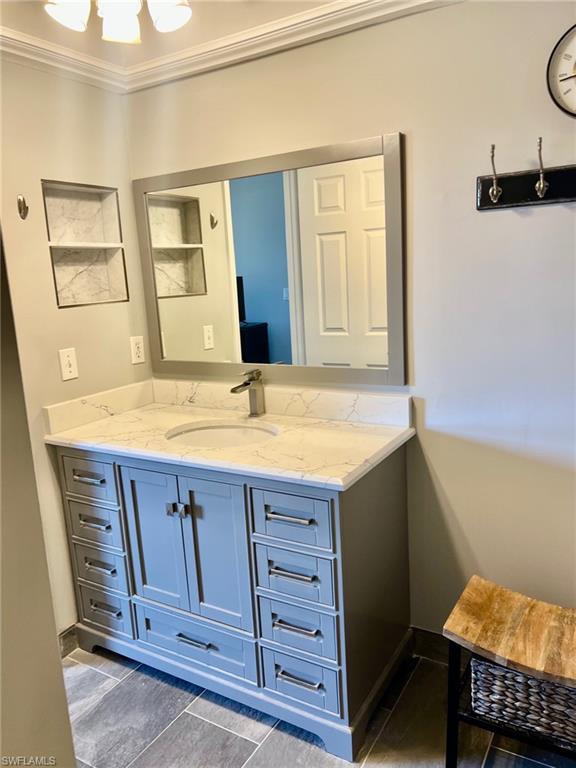 1790 Imperial Golf Course Boulevard, Unit A205 Naples, FL 34110 - Photo 16 of 28 a bathroom with a sink and a mirror