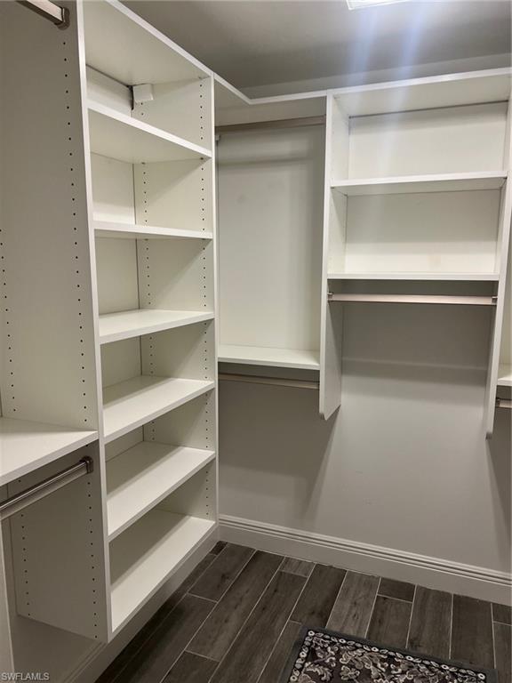 1790 Imperial Golf Course Boulevard, Unit A205 Naples, FL 34110 - Photo 17 of 28 a view of walk in closet with empty racks