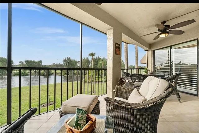 a living room with furniture and floor to ceiling windows