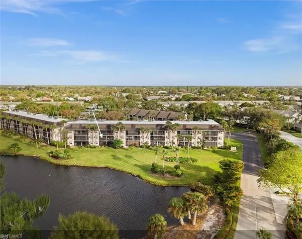 a view of a city with lawn chairs and large trees