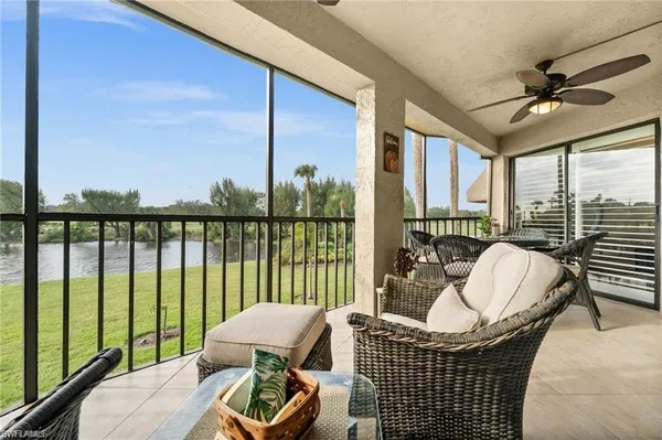 a living room with furniture and a floor to ceiling window