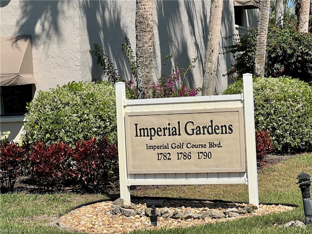 1790 Imperial Golf Course Boulevard, Unit A205 Naples, FL 34110 - Photo 23 of 28 a sign on the side of a building