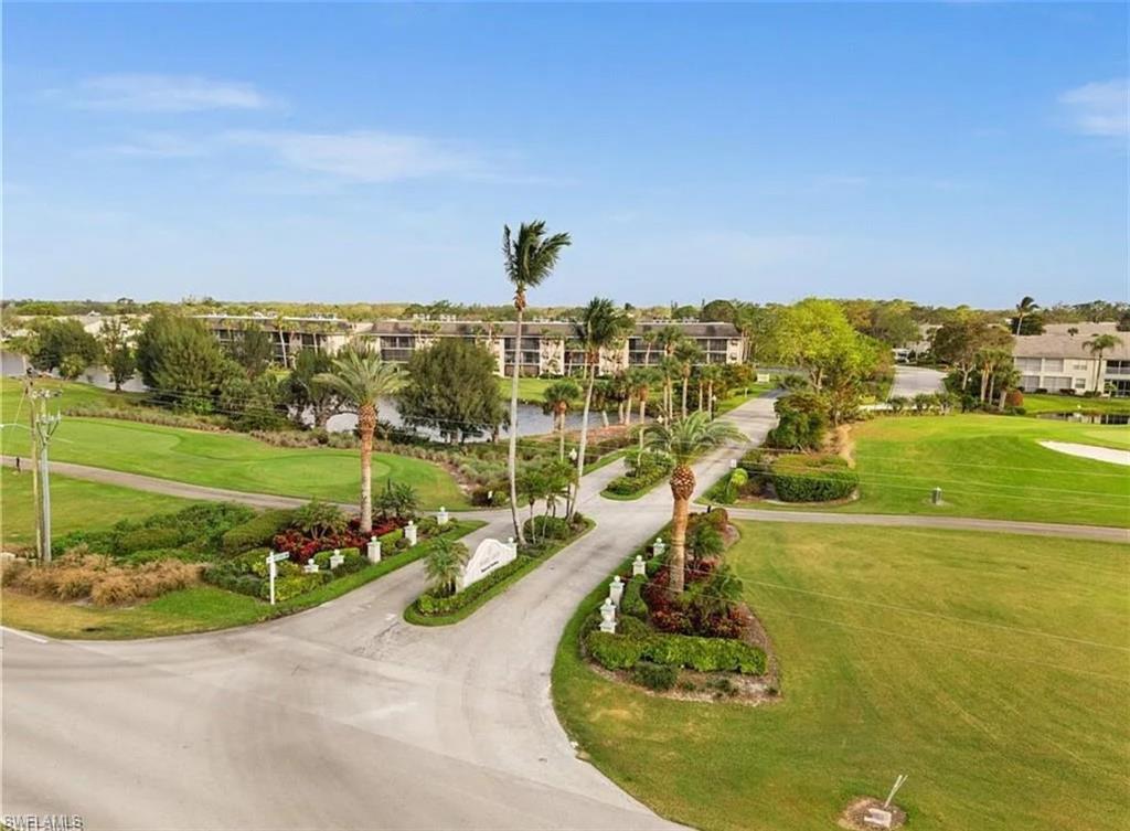 1790 Imperial Golf Course Boulevard, Unit A205 Naples, FL 34110 - Photo 25 of 28 a view of a swimming pool with a yard